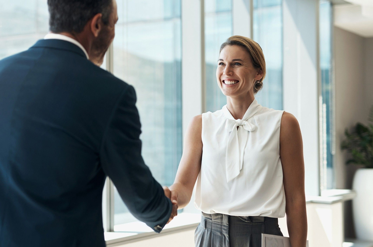 Real estate agent shakes hand with broker