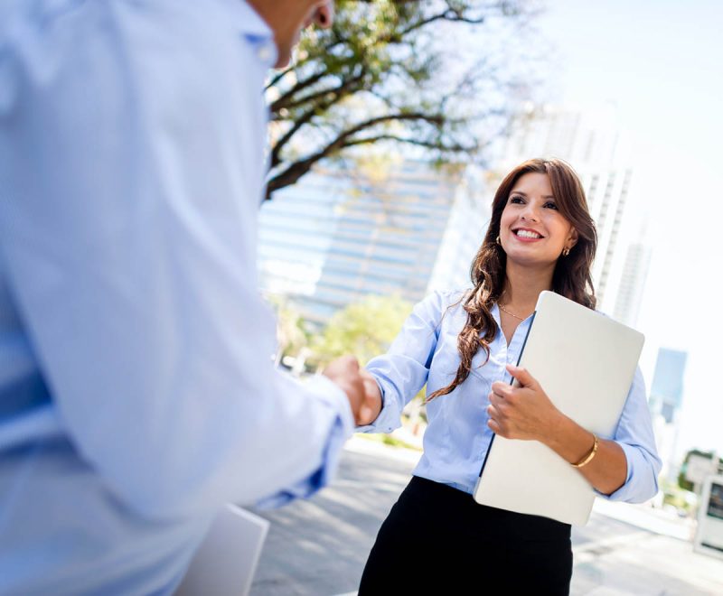 Florida real estate broker shakes hands with client