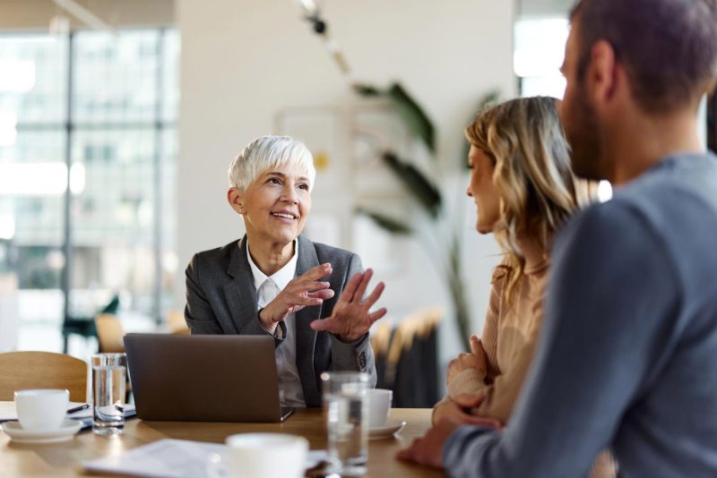 real estate agent negotiates with buyer clients