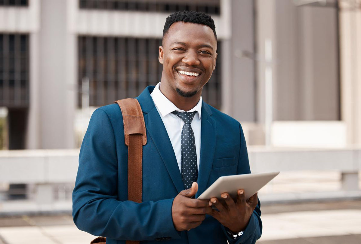 Man holding tablet. Learn about real estate agent demographics in FL.